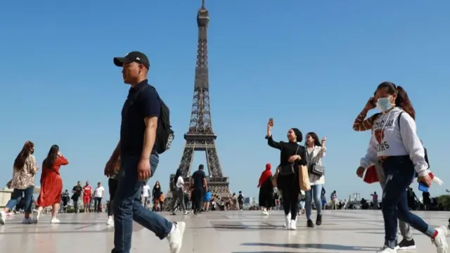 Tourists near the Eiffel Tower, on June 22, 2020, in Paris