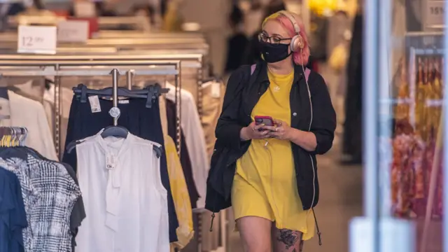 A woman shopping wearing a face mask