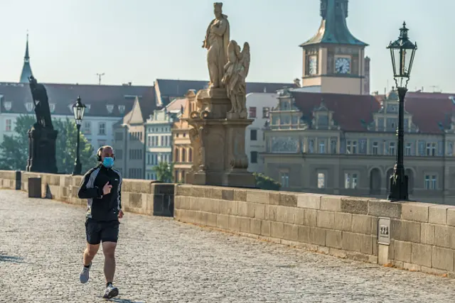 A man is seen running wearing a protective mask in Prague