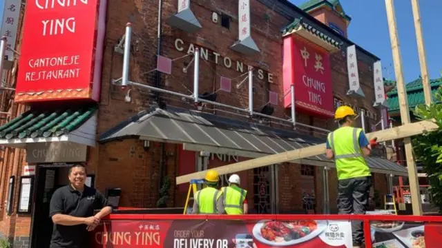 Builders putting the roof up at Chung Ying