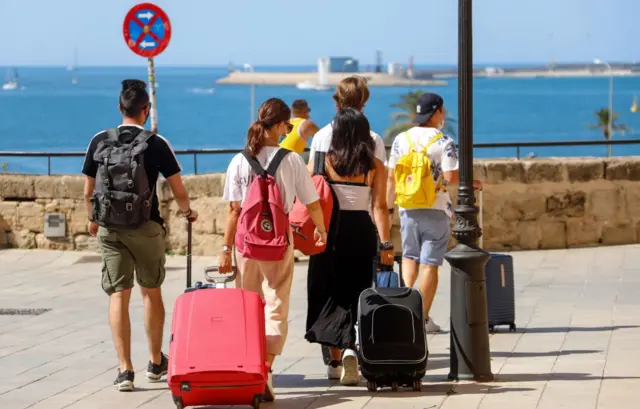 A group with suitcases in Spain