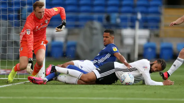 Michael Hector of Fulham keeps the ball away from Robert Glatzel of Cardiff City