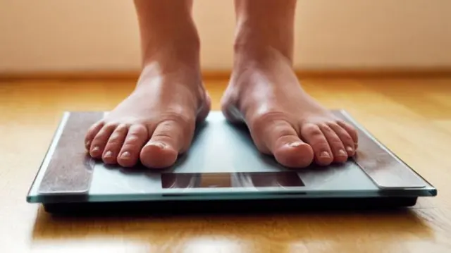 A person standing on scales