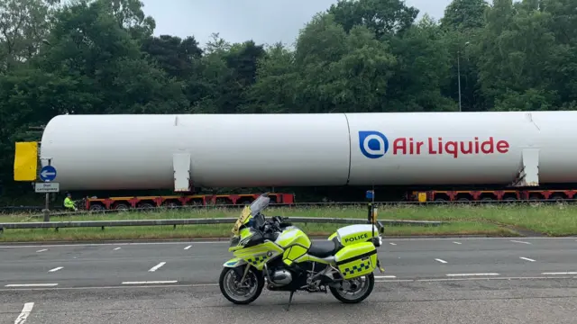 One of the cylinders next to a police motorbike