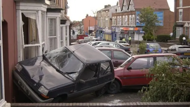 Cars smashed against houses