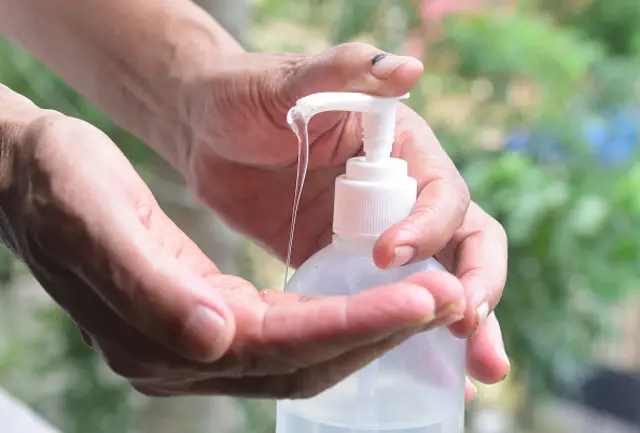 Image of person applying hand sanitiser