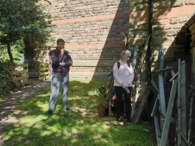 Rev Christopher Harrison and church warden Lorraine Smedley look at the damage.