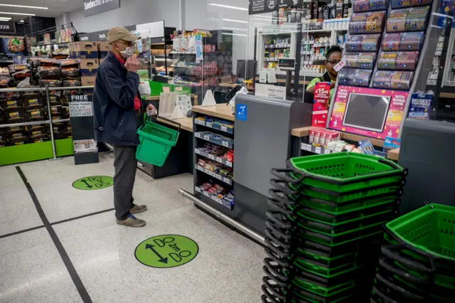 A customer wearing a mask in a supermarket