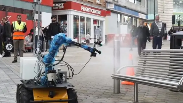 A robot spraying a bench