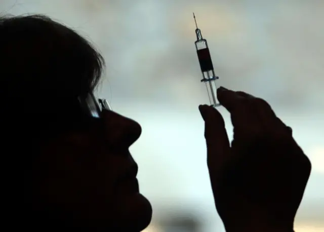 Generic photo of a nurse preparing to give a vaccination