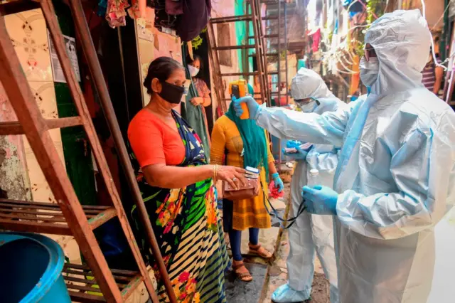 Health workers conducting health checks in Mumbai's dharavi slum