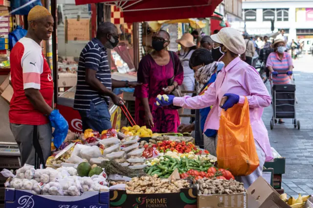 Shoppers at Brixton market wearing masks