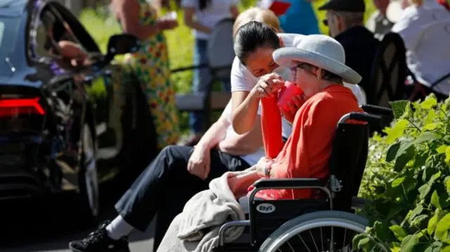 Nurse assisting woman