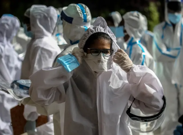 Indian health workers wearing personal protective equipment (PPE) gathered to carry medical checkup of the residents of a "containment zones" in Mumbai