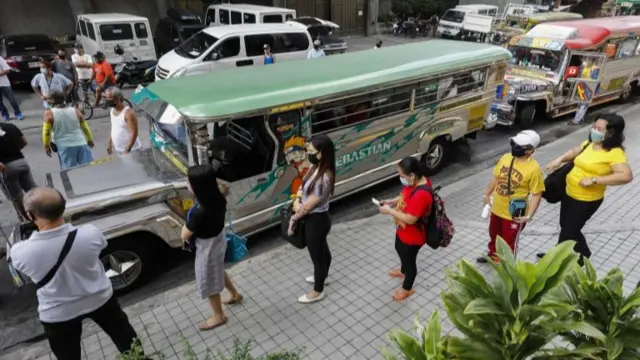 People wait to board jeepney in Manila