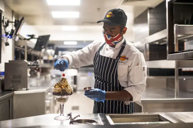 Chef in mask at Hard Rock Cafe in Piccadilly Circus, central London