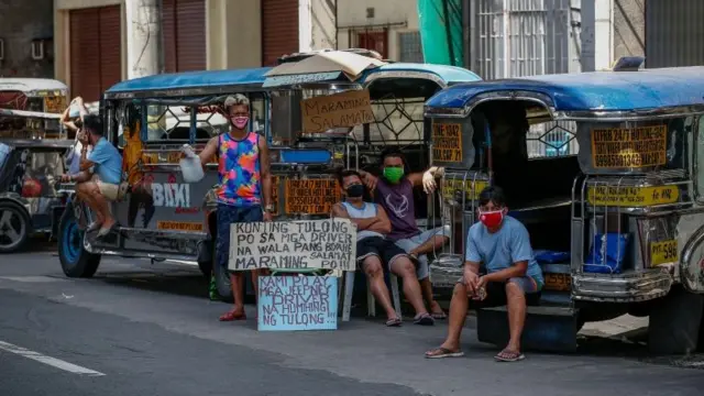 Drivers wait by their jeepneys