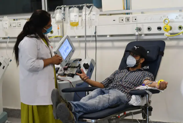 A man donating his blood in Delhi's plasma bank