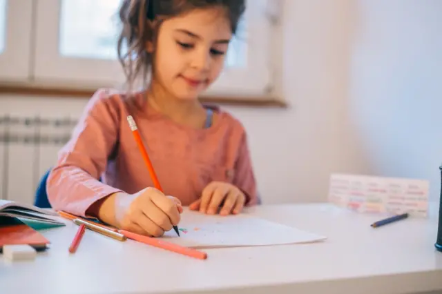 A girl doing schoolwork at home