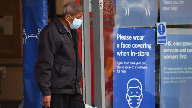 Man in mask leaving Leicester Tesco