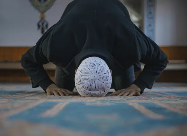 Muslim man praying in a mosque