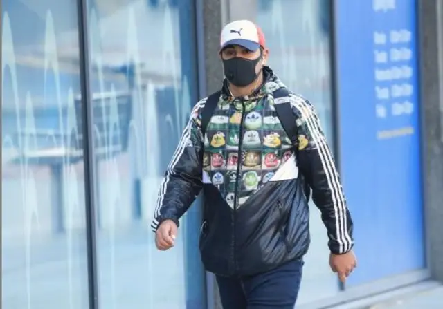 A man wearing a face mask walks through the centre of Bradford