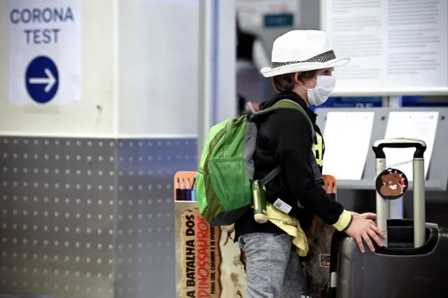 A traveller waits at a walk in testing centre at Dusseldorf Airport