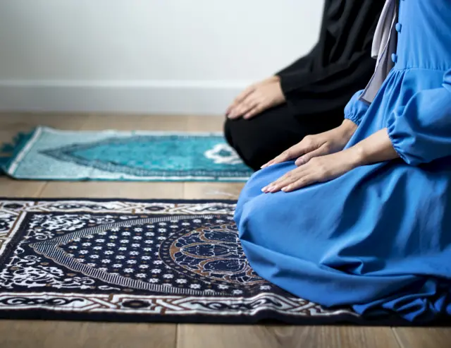 Two people praying in a Mosque