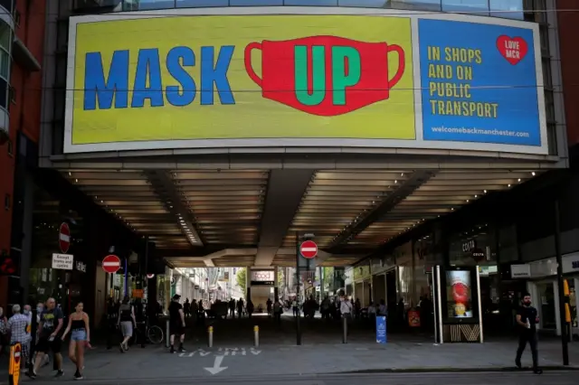 A sign telling people to wear a mask in Manchester, UK