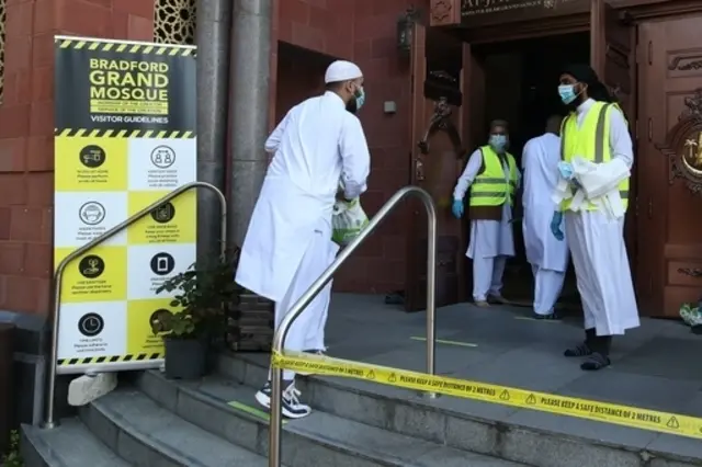 Worshippers observe social distancing as they arrive at the Bradford Grand Mosque in Bradford