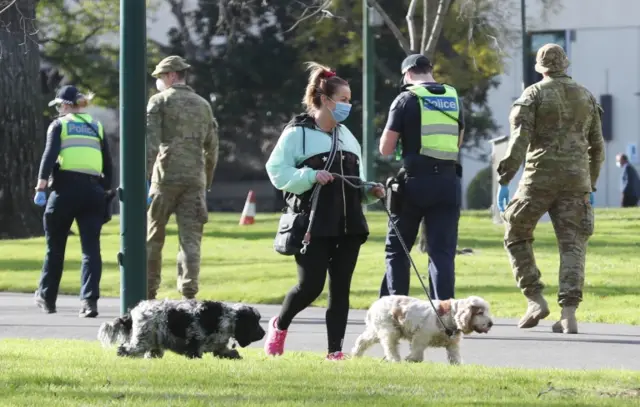 People walk through a park in Melbourne