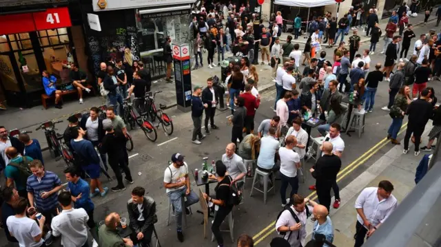 Drinkers in Soho, London, as coronavirus lockdown restrictions are eased across England. PA Photo.