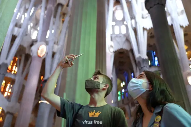 A man films on a mobile phone inside Barcelona's Sagrada Familia. Photo: 4 July 2020