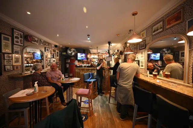 Customers drink inside The Ancoats Lad in Manchester