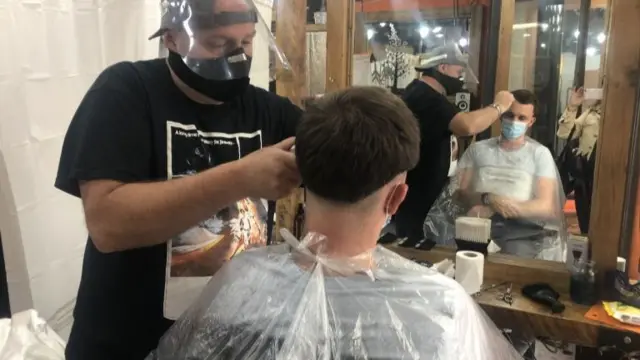 Barber cutting hair in Maclure