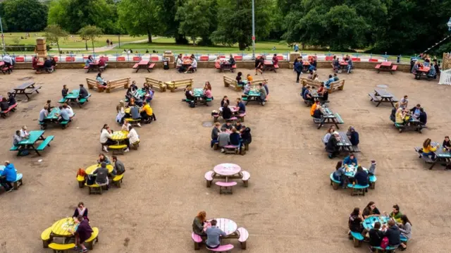 Visitors drink at The Terrace beer garden at Alexandra Palace on July 4, 2020 in London, United Kingdom. The UK Government announced that pubs, hotels and restaurants can open from Saturday, July 4th providing they follow guidelines on social distancing and sanitising.