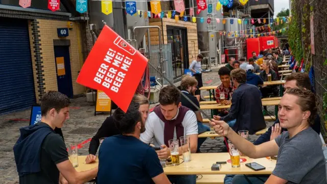 Friends from Bromley enjoy the vibe at Camden Town Brewerys pop-up beer garden on July 4, 2020 in London, United Kingdom. The UK Government announced that Pubs, Hotels and Restaurants can open from Saturday, July 4th providing they follow guidelines on social distancing and sanitising