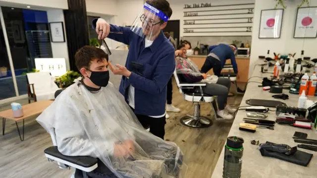 A customer has his hair cut at the Hoi Polloi men"s barbers on July 04, 2020 in Newcastle upon Tyne, England. Hairdressing Salons reopen today having been closed for over three months in the UK due to the Coronavirus Pandemic. Bars and restaurants will also open all with special measures in place to minimise the risk of spreading Covid-19.