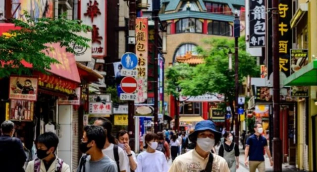 People wear face masks in Yokohama, Japan. File photo