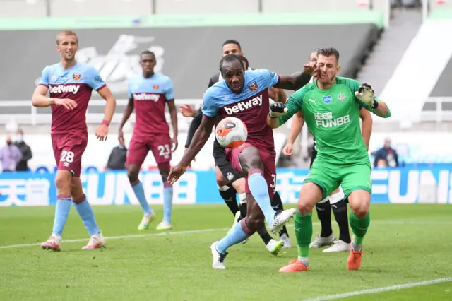 Michail Antonio of West Ham United battles for possession with Martin Dubravka of Newcastle United