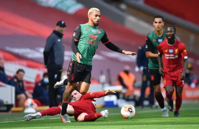 Andrew Robertson of Liverpool (floor) fouls Douglas Luiz of Aston Villa (C)