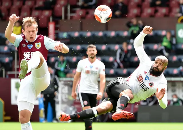 Matej Vydra (L) of Burnley in action against David Goldrick of Sheffield during the English Premier League match between Burnley and Sheffield United