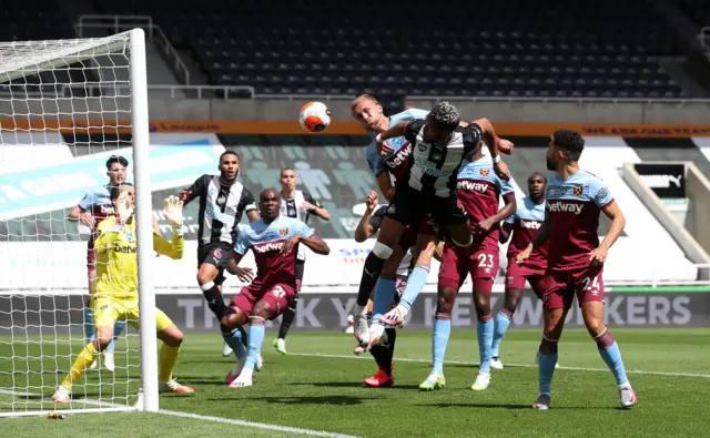 Newcastle United's Joelinton (centre) tries to direct a header towards goal