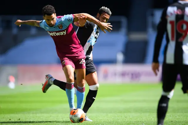 West Ham United's English defender Ryan Fredericks (L) fights for the ball with Newcastle United's Brazilian striker Joelinton