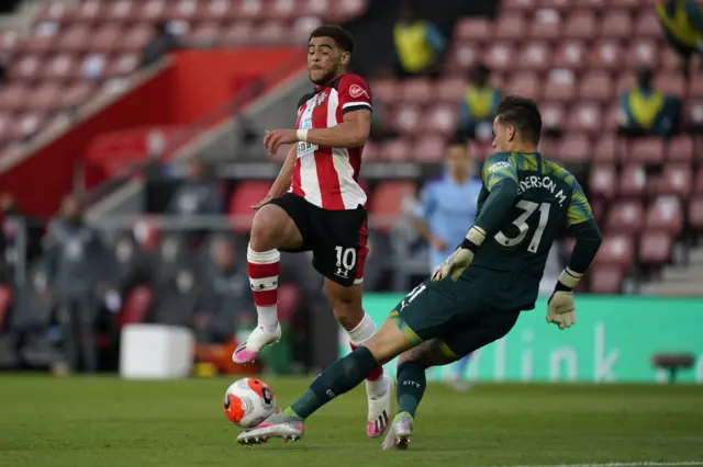 Ederson of Manchester City is challenged by Che Adams of Southampton