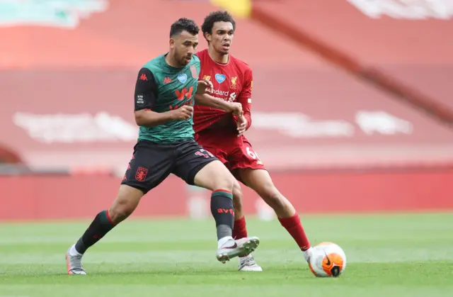 Trent Alexander-Arnold of Liverpool (R) in action against Trezeguet of Aston Villa (L)