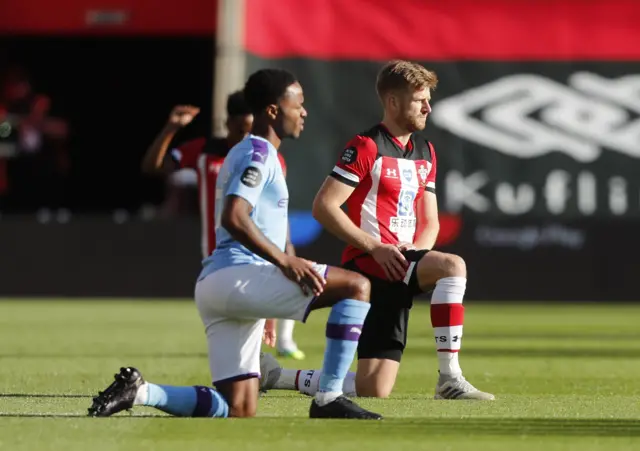 Manchester City's Raheem Sterling and Southampton's Stuart Armstrong kneel in support of the Black Lives Matter campaign