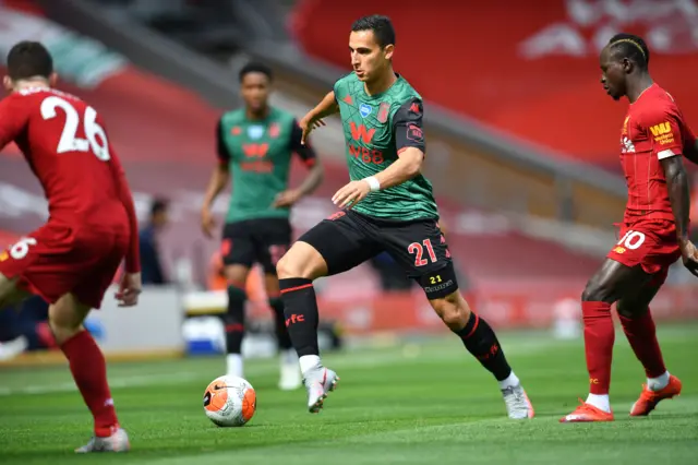 Anwar El Ghazi (C) runs with the ball