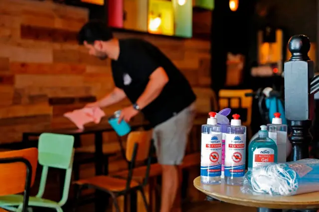 A worker cleans and disinfects the premises at a bar in Tel Aviv