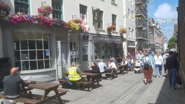 People sat outside a Guernsey pub